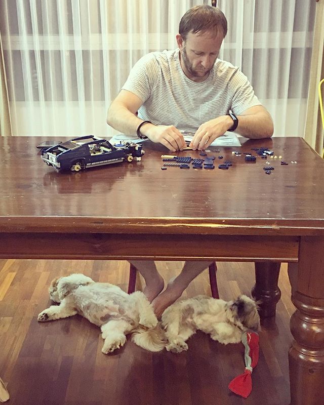 Building LEGO with his foot warmers ️
